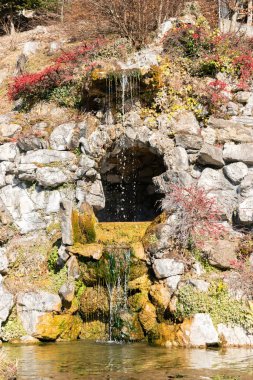 Saint Beatus, Canton Bern, Switzerland, February 12, 2023 Beautiful tiny waterfall flows down along some rocks at the Saint Beatus caves