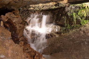 Saint Beatus, Canton Bern, Switzerland, February 12, 2023 Fantastic waterfall scenery surrounded with an incredible rock formation inside the Saint Beatus caves