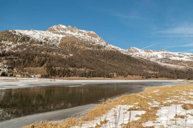 Silvaplana, Switzerland, February 21, 2023 Stunning winter landscape scenery with a frozen lake of Silvaplana