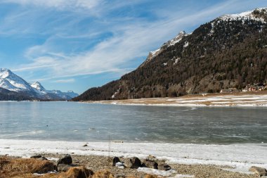 Silvaplana, Switzerland, February 21, 2023 Stunning winter landscape scenery with a frozen lake of Silvaplana