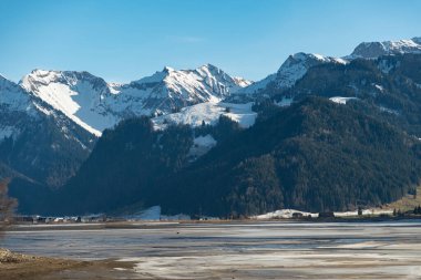 Einsiedeln area, Canton Schwyz, Switzerland, February 20, 2023 Stunning alpine scenery at the coast of the lake Sihlsee on a sunny winter day