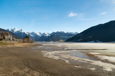 Einsiedeln area, Canton Schwyz, Switzerland, February 20, 2023 Stunning alpine scenery at the coast of the lake Sihlsee on a sunny winter day