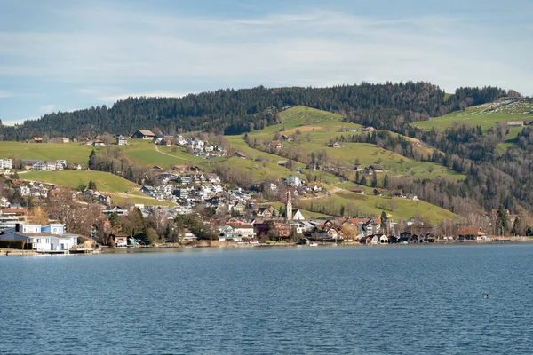 stock image Unteraegeri, Switzerland, February 20, 2023 Idyllic landscape at the waterfront of the lake Aegerisee on a sunny day