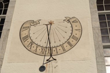 Thun, Switzerland, February 13, 2023 Historic old sundial painted on a wall clipart