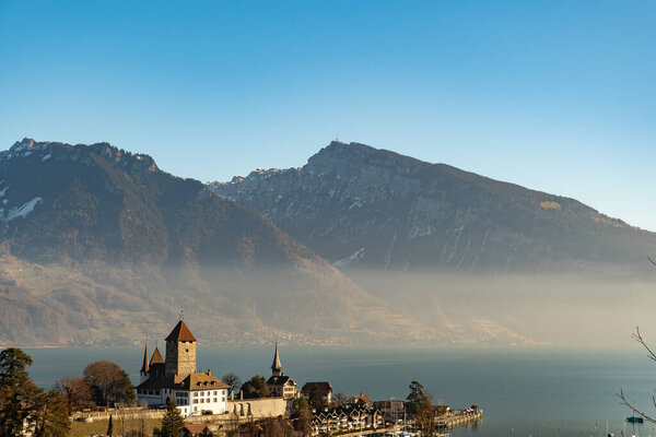 Фац, кантон Берн, Швейцария, 13 февраля 2023 г. Замок Фац на берегу озера Тун в солнечный день