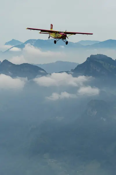 stock image Rhine Valley, Saint Gallen, Switzerland, May 20, 2023 N-283SW Pilatus PC-6/350-H2 Porter propeller airplane performance during an air show seen from the top of the mount hoher Kasten