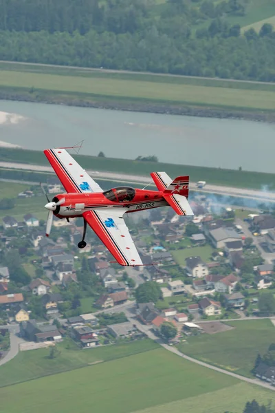 stock image Rhine Valley, Saint Gallen, Switzerland, May 20, 2023 HB-MSS Sukhoi SU-26M propeller airplane is performing during an air show seen from the top of the mount hoher Kasten