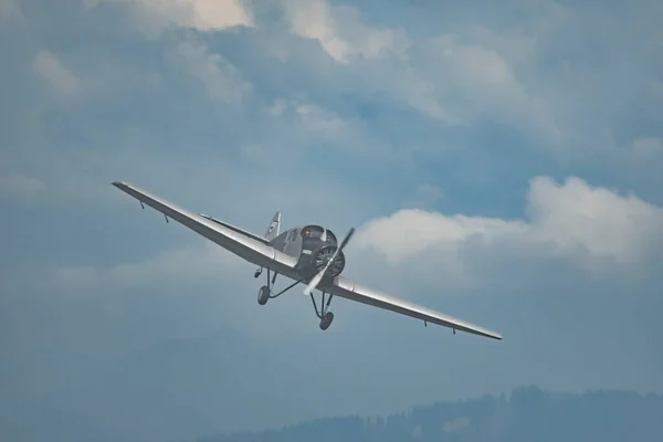 stock image Rhine Valley, Saint Gallen, Switzerland, May 20, 2023 HB-RIO Junkers F13 rebuilt nostalgic propeller airplane performance during an air show seen from the top of the mount hoher Kasten