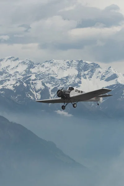 Stock image Rhine Valley, Saint Gallen, Switzerland, May 20, 2023 HB-RIO Junkers F13 rebuilt nostalgic propeller airplane performance during an air show seen from the top of the mount hoher Kasten