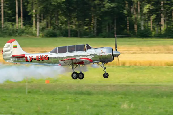 stock image Speck-Fehraltorf, Zurich, Switzerland, July 1, 2023 LY-EUG Jakowlew Jak-52 historic propeller airplane is taking off from a small airfield