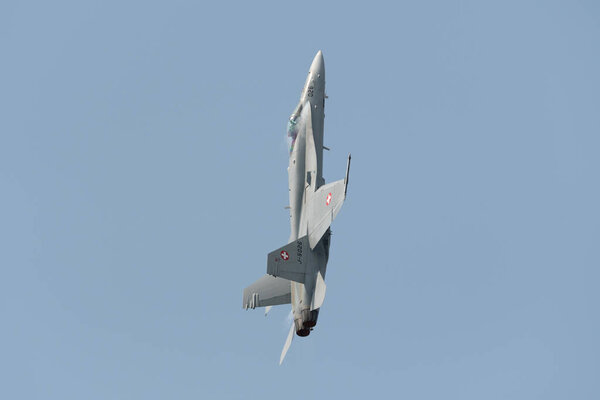 Speck-Fehraltorf, Zurich, Switzerland, July 1, 2023 McDonnell Douglas F/A-18 Hornet swiss military fighter is doing performances during an air show overhead a small airfield
