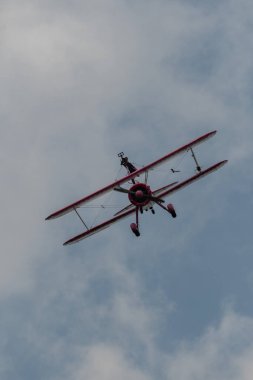 Speck-Fehraltorf, Zürih, İsviçre, 2 Temmuz 2023 N-450D Boeing PT-13D tarihi çift katlı uçak hava gösterisi sırasında kanat yürüyüşü yapan bir kadınla