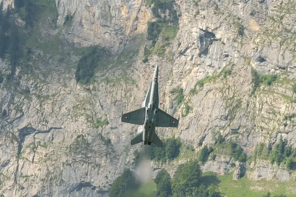 Mollis, İsviçre, 18 Ağustos 2023 İsviçre ordusu McDonnell Douglas F / A-18 Hornet jeti hava gösterisi sırasında akrobasi yapıyor.