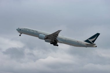 Zürih, İsviçre, 6 Aralık 2023 B-KPI Cathay Pasifik Boeing 777-367ER uçağı kışın 16. pistten kalkıyor.