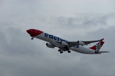 Zürih, İsviçre, 6 Aralık 2023 HB-JMF Edelweiss Air Airbus A340-313 sefer sayılı uçak kış mevsiminde 16. pistten havalanmıştır.