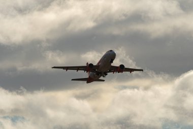 Zürih, İsviçre, 4 Ocak 2024 G-EZDH Easy Jet Airbus A319-111 uçağı bulutlu bir günde 32 numaralı pistten kalkıyor.