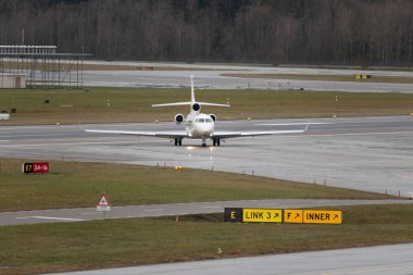 Zürih, İsviçre, 18 Ocak 2024 OO-LUM Belçika Hava Kuvvetleri Dassault Falcon 7X uçağı Davos 'taki dünya ekonomik forumu sonrasında yağmurda taksicilik yapıyor.