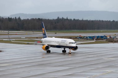 Zürih, İsviçre, 18 Ocak 2024 TF-FIK İzlanda Hava Yolları Boeing 757-256 bir yağmur yağışı sırasında kapıya doğru ilerliyor.