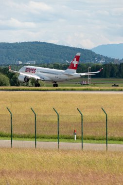 Zurich, Switzerland, June 16, 2024 HB-JBH Swiss international airlines Bombardier CS-100 or Airbus A220 aircraft is landing on runway 14 clipart