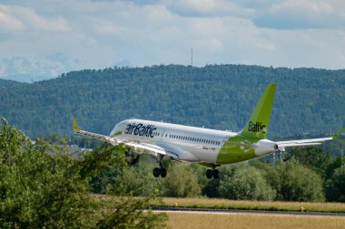 Zurich, Switzerland, June 16, 2024 YL-ABD Air Baltic Bombardier CS-300 0r Airbus A220 aircraft is landing on runway 14 clipart