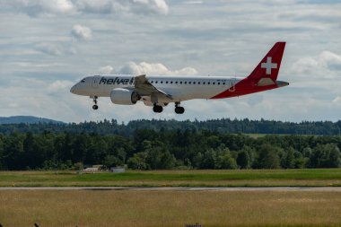 Zurich, Switzerland, June 16, 2024 HB-AZB Helvetic Airways Embraer E190-E2 aircraft is landing on runway 14 clipart