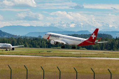 Zürih, İsviçre, 16 Haziran 2024 HB-JVM Helvetic Airways Embraer E190LR uçağı 14 numaralı piste iniyor.