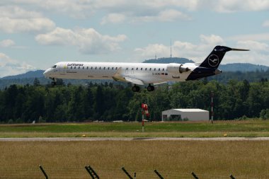 Zürih, İsviçre, 16 Haziran 2024 D-ACNX Lufthansa Mitsubishi CRJ-900LR uçağı 14 numaralı piste iniyor.