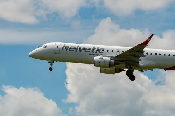 stock image Zurich, Switzerland, June 16, 2024 HB-JVP Helvetic Airways Embraer E190LR aircraft is landing on runway 14