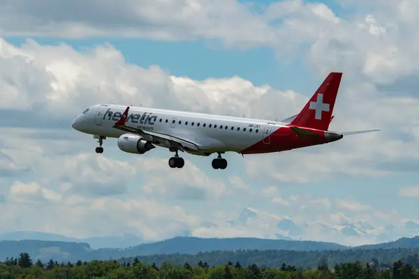 stock image Zurich, Switzerland, June 16, 2024 HB-JVY Helvetic airways Embraer E190LR aircraft is landing on runway 14