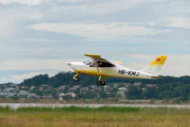 Wangen-Lachen, Switzerland, May 26, 2024 HB-KMJ Tecnam P2008-JC propeller plane is departing from a small airfield clipart