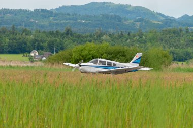 Wangen-Lachen, Switzerland, May 26, 2024 HB-PMG Piper PA-28 Archer II propeller plane on a small airfield clipart