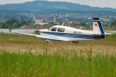 Wangen-Lachen, İsviçre, 26 Mayıs 2024 HB-DIA Mooney Mooney M20J pervane uçağı küçük bir havaalanına iniyor.