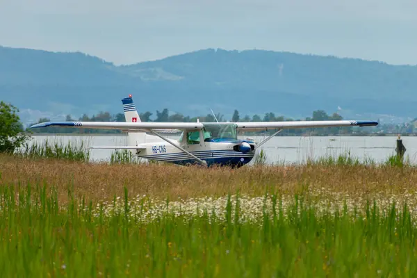 Stock image Wangen-Lachen, Switzerland, May 26, 2024 HB-CNS Reims Cessna F152 propeller plane is departing from a small airfield