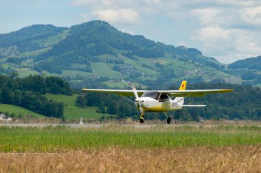 Wangen-Lachen, Switzerland, May 26, 2024 HB-KMJ Tecnam P2008-JC propeller plane is landing on a small airfield clipart