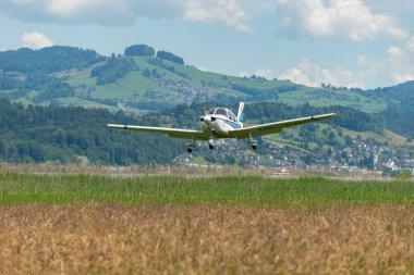 Wangen-Lachen, İsviçre, 26 Mayıs 2024 HB-PMG Piper PA-28 Archer II pervane uçağı küçük bir havaalanına iniyor.