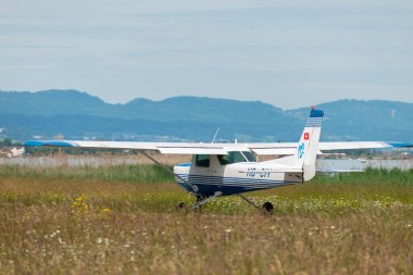 Wangen-Lachen, Switzerland, May 26, 2024 HB-CIY Reims Cessna F152 propeller plane on a small airfield clipart