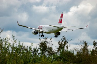 Zürih, İsviçre, 14 Eylül 2024 HB-JCU İsviçreli bombardıman uçağı CS-300 veya Airbus A220-300 uçağı bulutlu bir günde 14 nolu piste iniyor.
