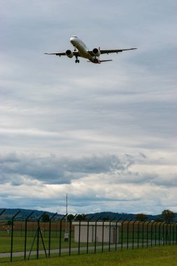 Zürih, İsviçre, 14 Eylül 2024 HB-AZL Helvetic Hava Yolları Embraer E195-E2 uçağı bulutlu bir günde 14. piste iniyor.