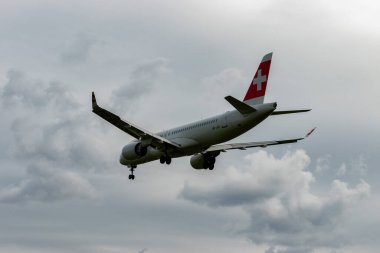 Zürih, İsviçre, 14 Eylül 2024 HB-JCU İsviçreli bombardıman uçağı CS-300 veya Airbus A220-300 uçağı bulutlu bir günde 14 nolu piste iniyor.