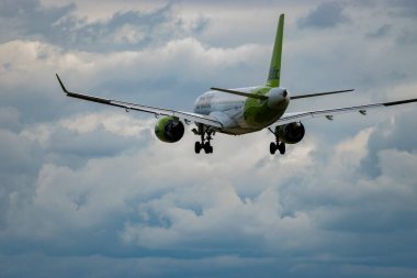 Zurich, Switzerland, September 14, 2024 YL-ABP Air Baltic Bombardier CS-300 or Airbus A220 aircraft is landing on runway 14 on a cloudy day clipart