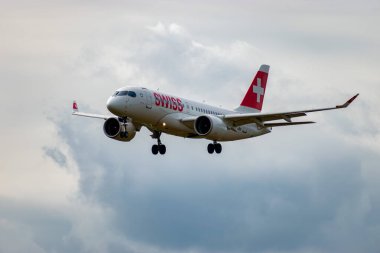 Zurich, Switzerland, September 14, 2024 HB-JBH Swiss Bombardier CS-100 or Airbus A220-100 aircraft is landing on runway 14 on a cloudy day clipart