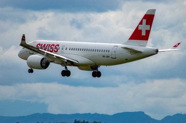 Zurich, Switzerland, September 14, 2024 HB-JBH Swiss Bombardier CS-100 or Airbus A220-100 aircraft is landing on runway 14 on a cloudy day clipart