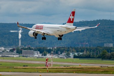 Zürih, İsviçre, 14 Eylül 2024 HB-JBH İsviçreli bombardıman uçağı CS-100 veya Airbus A220-100 uçağı bulutlu bir günde 14 nolu piste iniyor.