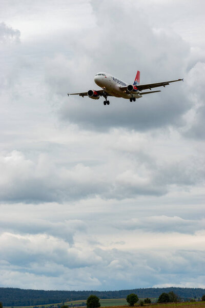 Zurich, Switzerland, September 14, 2024 Yu-APN Air Serbia Airbus A319-132 aircraft is landing on runway 14 on a cloudy day