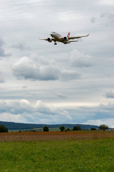 Zurich, Switzerland, September 14, 2024 HB-JBF Swiss international airlines Bombardier CS-100 or Airbus A220-100 aircraft is landing on runway 14 on a cloudy day