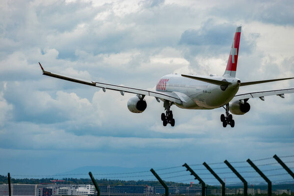 Zurich, Switzerland, September 14, 2024 HB-JHA Swiss international airlines Airbus A330-343 aircraft is landing on runway 14 on a cloudy day