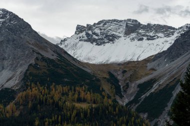 Arosa, Switzerland, October 12, 2024 Alpine view with snow covered mountains in autumn clipart