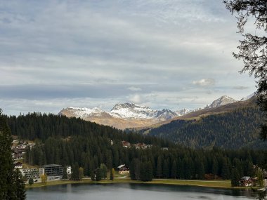 Arosa, Switzerland, October 12, 2024 Majestic view over the city and the lake on a sunny day in autumn clipart