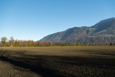 Schaan, Liechtenstein, November 16, 2024 Rural and alpine scenery during a bike tour on a sunny day clipart