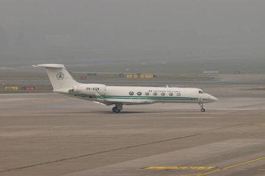 Zurich, Switzerland, January 20, 2025 5N-FGW Nigerian Air Force Gulfstream G550 aircraft is taxiing on a very foggy day during the world economic forum in Davos clipart